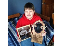 Here's the young guy with his picture and engraved completed mount.